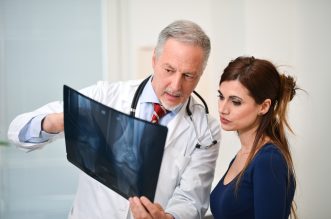 Doctor,Showing,A,Radiography,To,His,Patient