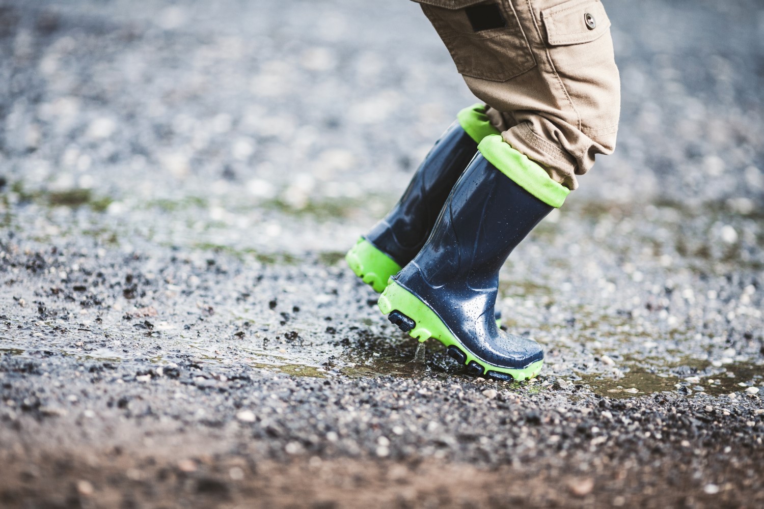 Toddler wearing rubber boots in rainy weather